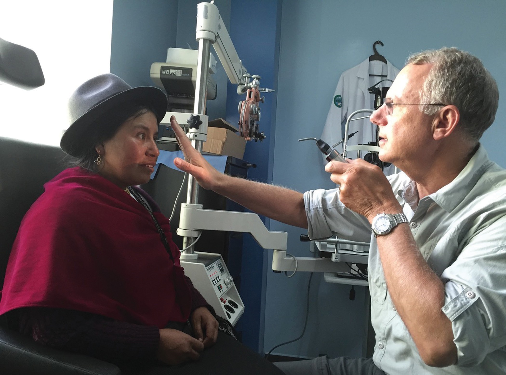 A doctor giving an eye exam to a patient