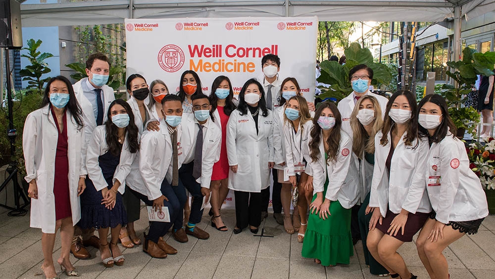 Drs. Yoon Kang, Mary E. Choi and Augustine M.K. Choi celebrate with the Class of 2024 at the White Coat Ceremony on Sept. 24, 2021.