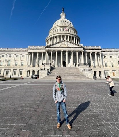 A man standing in front of the Capitol building