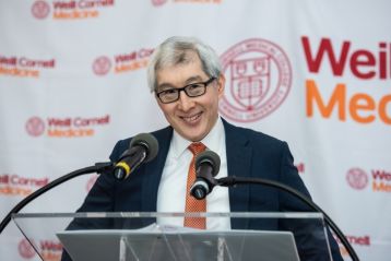 a man in a suit at a podium